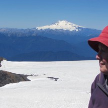 Marion on top of Volcan Calbuco (2003 meters high) with white Cerro Tronador in the background